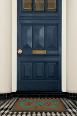 Monkey See Monkey Do Turquoise Doormat by Iris Apfel